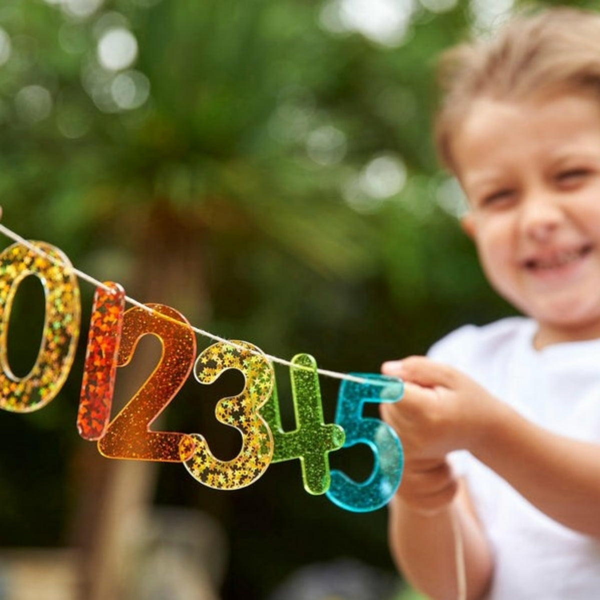 Glitter cijferset in gebruik – kind speelt met glitter cijfers